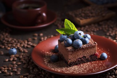 Chocolate cake with blueberries and mint . clipart