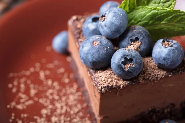 Chocolate cake with blueberries and mint . — Stock Photo, Image