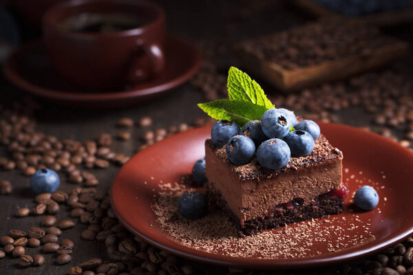 Chocolate cake with blueberries and mint .