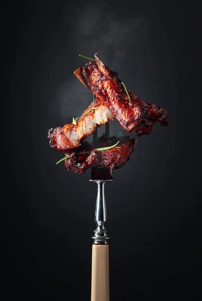 Grilled pork belly with rosemary on a fork. — Stock Photo, Image