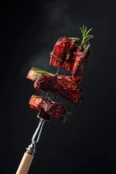 Grilled pork belly with rosemary on a fork. — Stock Photo, Image