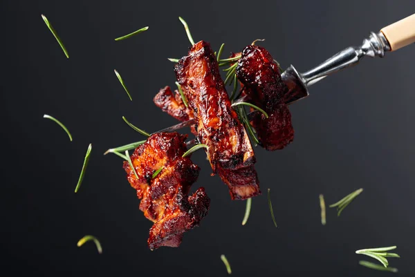 Grilled pork belly with rosemary on a fork. — Stock Photo, Image