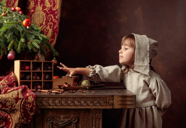 과자와 테이블 근처 빈티지 린넨 드레스에 어린 소녀 — 스톡 사진