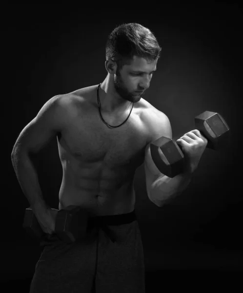Brutal strong bodybuilder athletic fitness man pumping up muscle — ストック写真