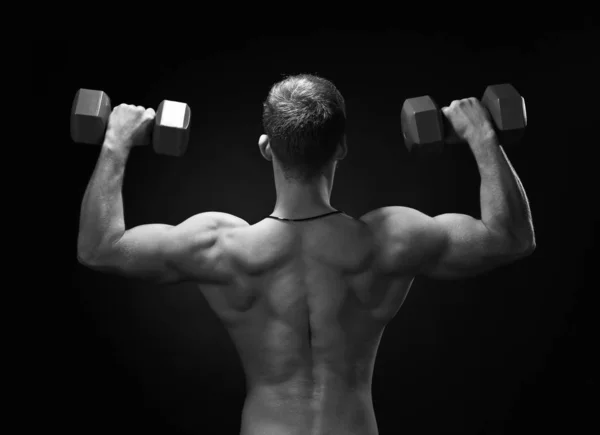Brutal strong bodybuilder athletic fitness man pumping up muscle — ストック写真