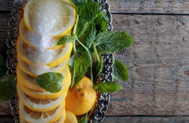 Şeker ve nane yaprakları ile limon dilimleri.