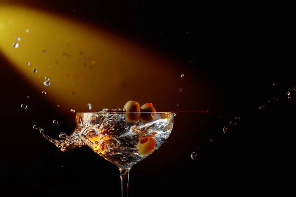 Martini with green olives. Cocktail in glass with splashes. — Stock Photo, Image