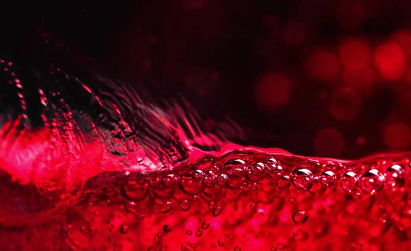 Red wine on black background, abstract splashing. — Stock Photo, Image