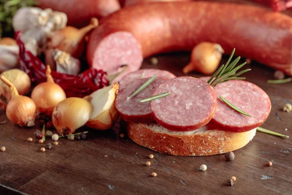 Sandwich with salami on a old wooden table. — Stock Photo, Image