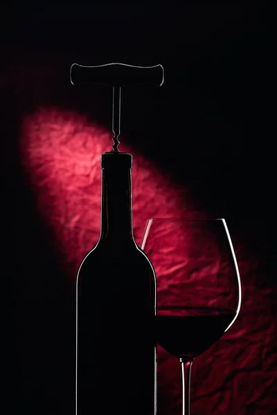 Bottle with corkscrew and glass of red wine. — 스톡 사진