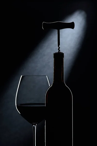 Bottle and glasses of red wine on a dark background. — ストック写真