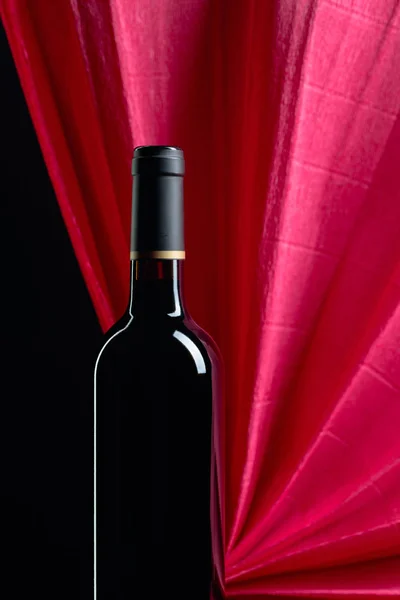 Closed bottle of red wine on a black background. Copy space. — Stock Photo, Image