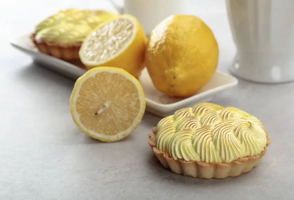 Tartlets with lemon cream on a white table.