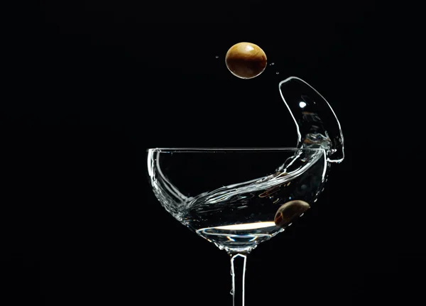 Silhouette of martini with green olives on a black background. — 스톡 사진