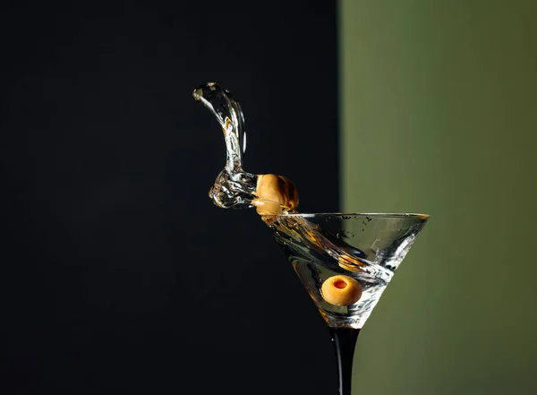 Martini with green olives splash. — Stock Photo, Image