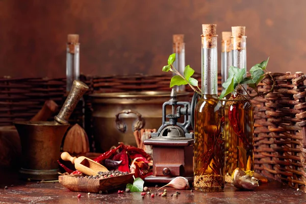 Bottles of olive oil with various spices and vintage cooking ute — Stock Photo, Image