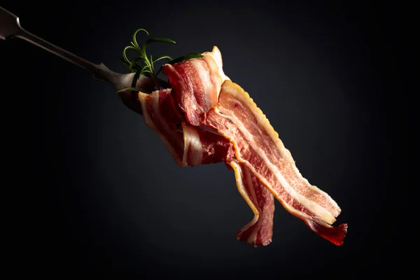 Slices Tasty Fried Bacon Garnished Rosemary Black Background — Stock Photo, Image