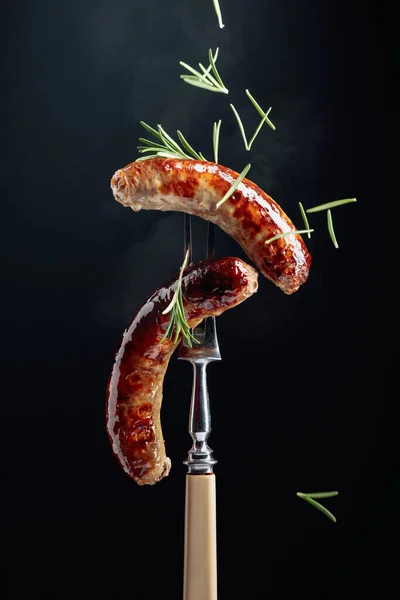 烤巴伐利亚香肠配迷迭香叉子上撒满迷迭香的香肠 — 图库照片