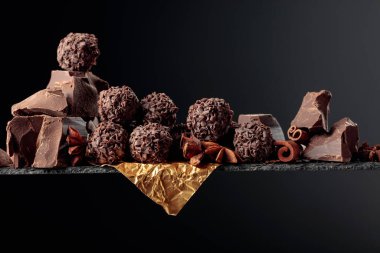  Çikolata, tarçın çubukları ve koyu bir arka planda anason. Boşluğu kopyala.