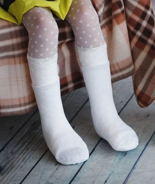 Child's feet are bandaged. Gypsum, disabled