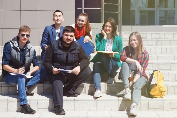 Los estudiantes se sientan en las escaleras . — Foto de Stock