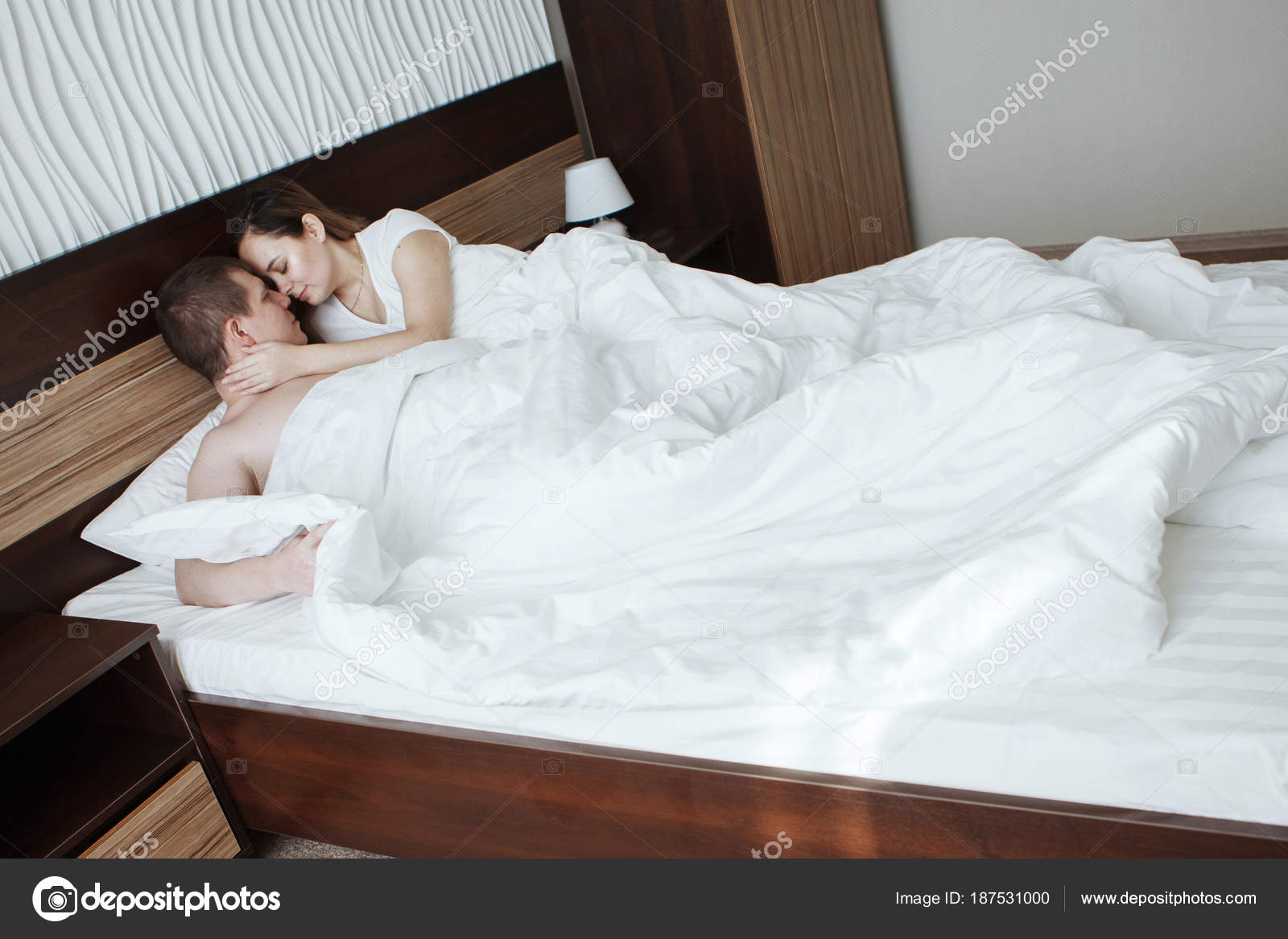 Happy Mature Couple In Spa Bathrobes Drinking Coffee In Hotel Room Stock Photo