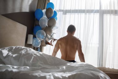Happy couple in a hotel room.