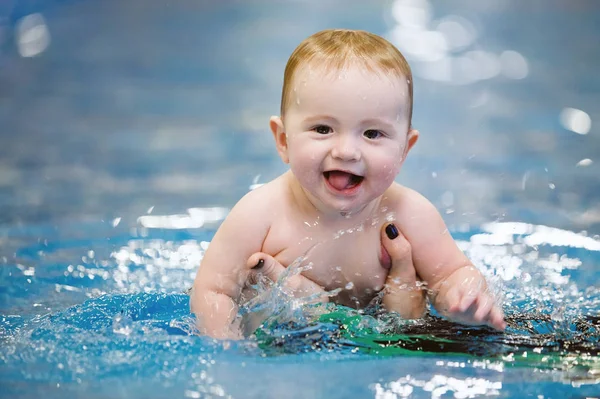 Toddler swim in water pool.
