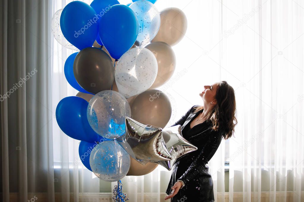 Young woman with a bunch of balloons.