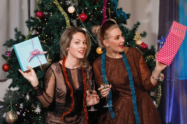 Dvě Přítelkyně Dávají Dárkové Krabice Blízko Vánočního Stromečku — Stock fotografie