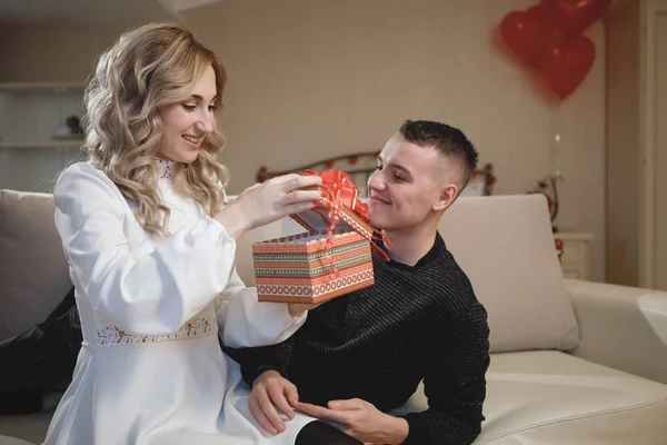 Man gives a woman a gift. Birthday Celebration Concept, Just Married, Valentine\'s Day.