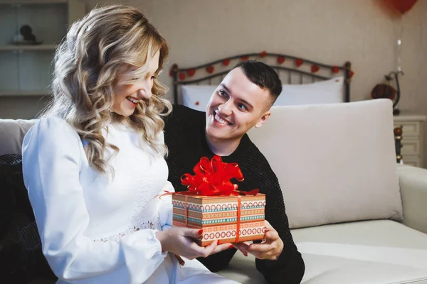 Man gives a woman a gift. Birthday Celebration Concept, Just Married, Valentine's Day.