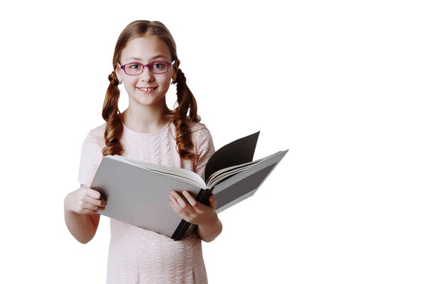 Portrait of a teenage girl with long hair in glasses and with a book on a white isolated background.
