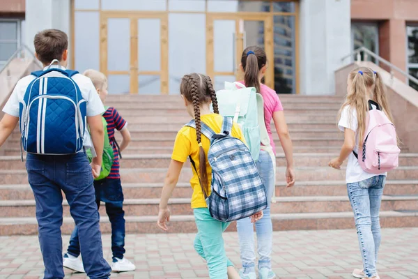 Skolbarn Med Ryggsäckar Springer Upp Till Skolan För Lektioner Bakifrån — Stockfoto