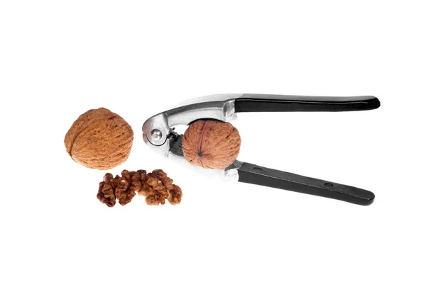 Nutcracker and a walnut isolated on a white background. — Stock Photo, Image