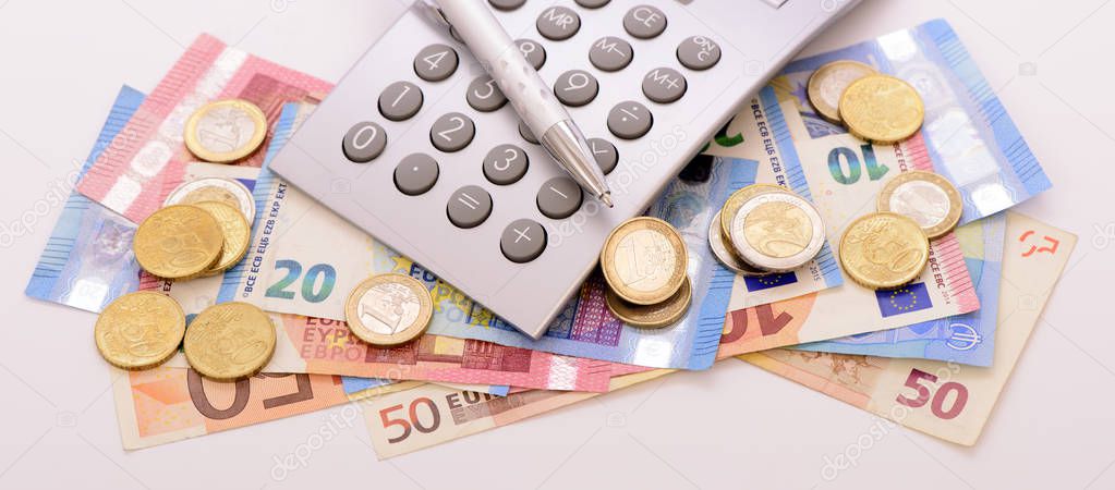  Euro currency with banknotes, calculator and coins