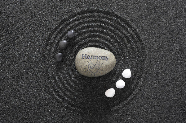 Japanese Zen garden with yin and yang stones and harmony in text