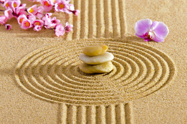 Japanese Zen garden with stacked stones in textured sand