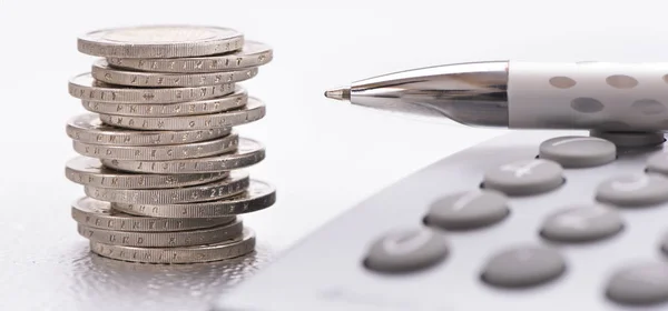 Stacked euro coins and calculator laying on financial business c — Stock Photo, Image