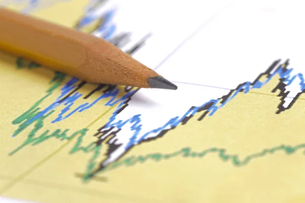 Pencil laying on financial business chart — Stock Photo, Image