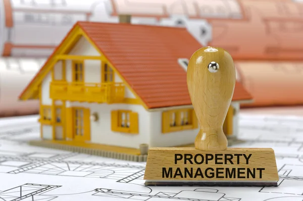 Property management printed on rubber stamp with model house and — Stock Photo, Image