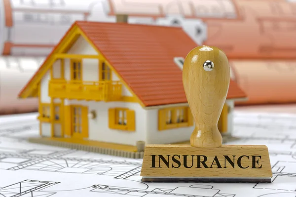 Insurance marked on rubber stamp with model house and constructi — Stock Photo, Image