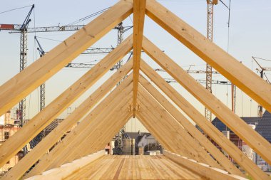Roof truss with wooden beams in a new building clipart