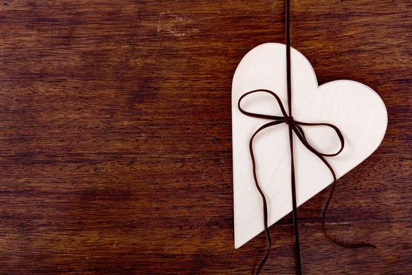 Bright wooden heart tied with a strap — Stock Photo, Image