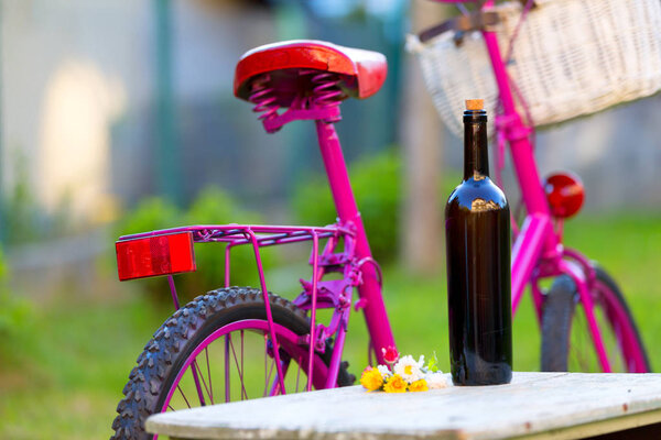 bottle of wine and pink bike