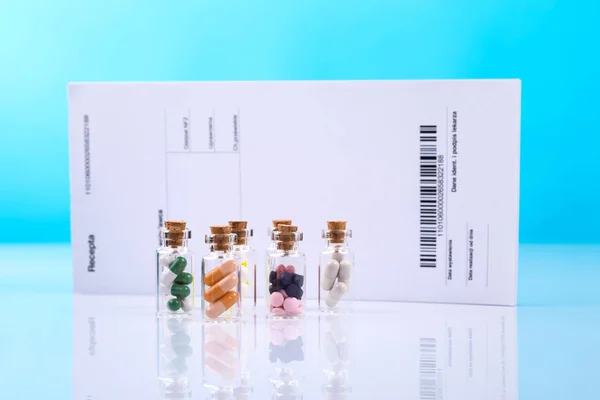 Vials with colorful capsules — Stock Photo, Image