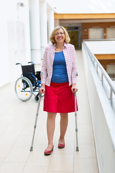 woman practicing walking on crutches