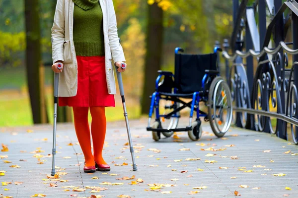 woman practicing walking on crutches