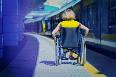 woman sitting on wheelchair on a platform