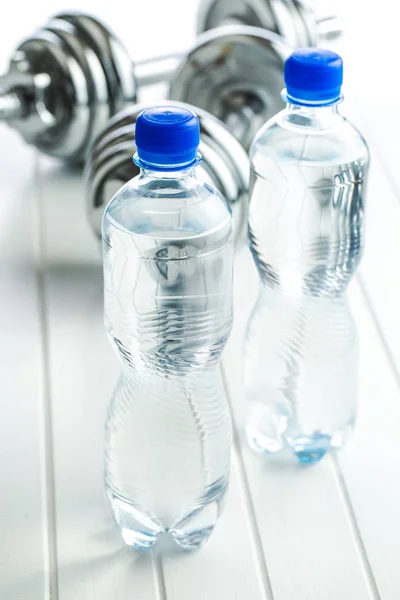 Bottle water and dumbbell. — Stock Photo, Image